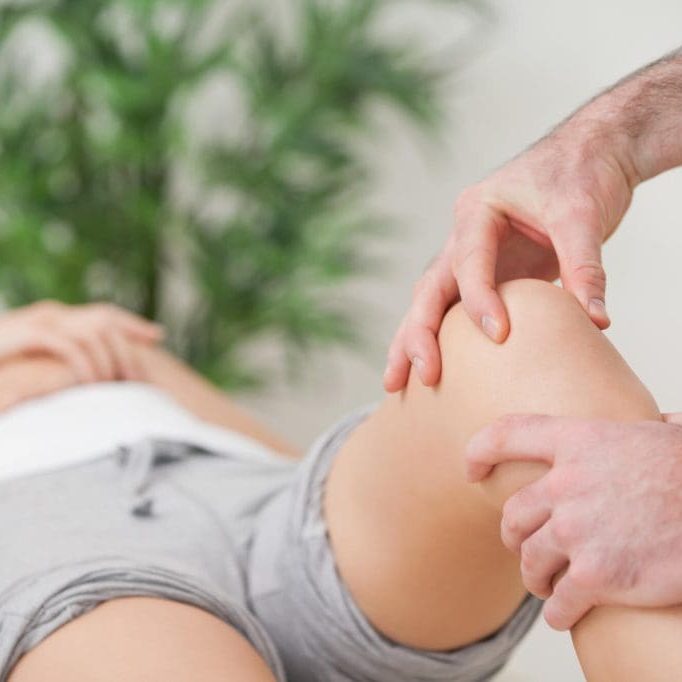 Practitioner,Using,His,Fingers,To,Massage,A,Knee,In,A